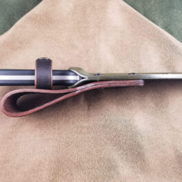 a pair of scissors sitting on top of a piece of cloth.