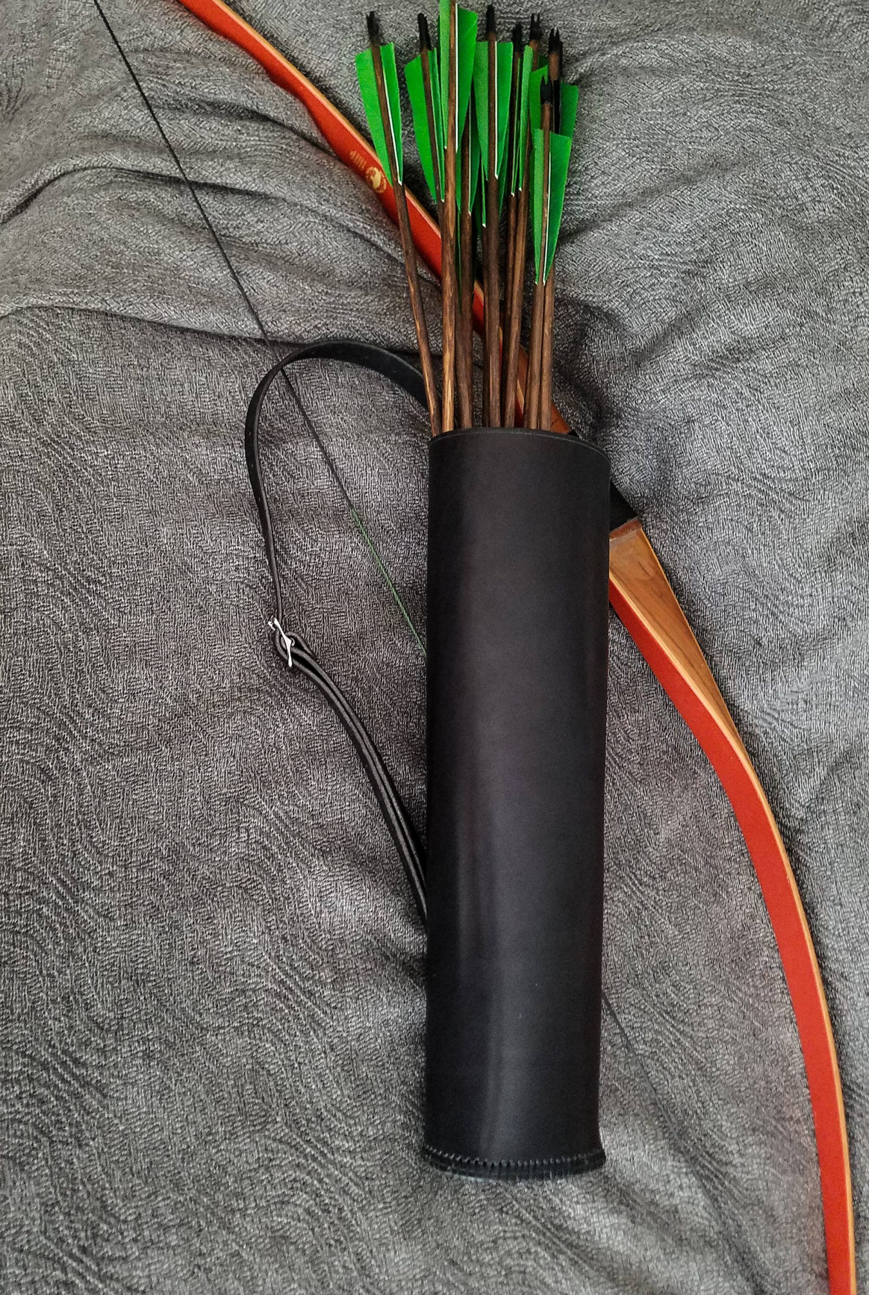 a black Basic Back Quiver with arrows laid on a cloth - renaissance clothing - renaissance clothing men - renaissance clothing women - renaissance clothing near me - renaissance costume ideas - sword baldrics - baldrics leather - baldric belt