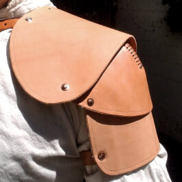 a person wearing a tan leather shoulder bag.