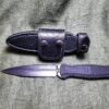 a knife and sheath laying next to each other.
