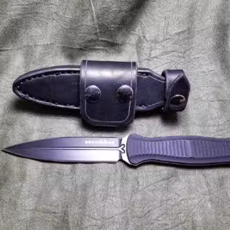 a knife and sheath laying next to each other.