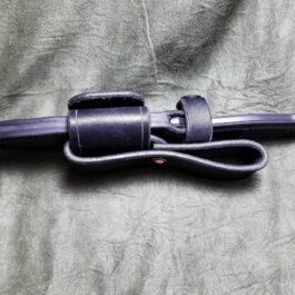 a close up of a Benchmade Fixed Infidel sheath on a bed.
