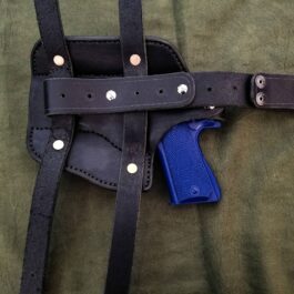 A Handmade Leather Thigh Holster with a blue gun in it.