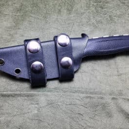 A Kydex sheath for the Benchmade Steep Country that is laying on a table.