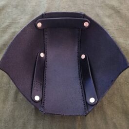 a stitched leather back of the head protection with two knives in it.