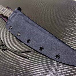 The Kydex Sheath for the TOPS Wild Pig Hunter is laying on top of the table.