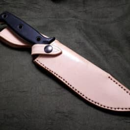 a knife with a black handle on a black background.