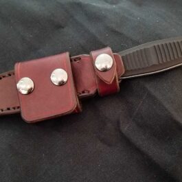 A Benchmade Fixed Infidel knife with a Handmade Leather Sheath on a black cloth.