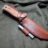 Handmade leather Sheath for the TOPS Fieldcraft Knife laid on a cloth - renaissance clothing - renaissance clothing men - renaissance clothing women - renaissance clothing near me - renaissance costume ideas - sword baldrics - baldrics leather - baldric belt