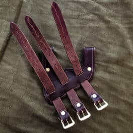 a pair of leather stirs on a bed.