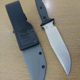 a knife and a knife sheath on a table.