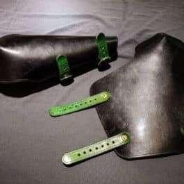 a pair of green straps sitting on top of a black case.