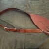 brown Renaissance baldric laid on a cloth - renaissance clothing - renaissance clothing men - renaissance clothing women - renaissance clothing near me - renaissance costume ideas - sword baldrics - baldrics leather - baldric belt