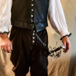a man wearing a black vest and a white shirt.