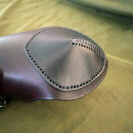 a close up of a saddle on a bed.