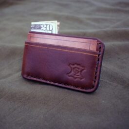 a wallet with money sticking out of it.