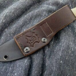 a Kydex sheath with a tan leather handle for the Benchmade Puukko.