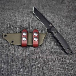 A Kydex Sheath for the Benchmade Protagonist sitting on top of a piece of cloth.