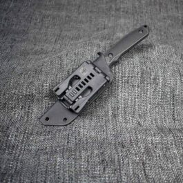 a Kydex Sheath for the Benchmade Protagonist laying on a gray cloth.