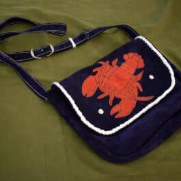 a Frontier Suede Saddlebag with a red lobster on it.