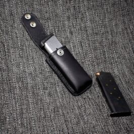 a 1911 Single Magpouch on a gray cloth.