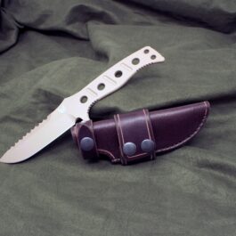 A Handmade Leather Sheath for the Benchmade Fixed Adamas on a green cloth.