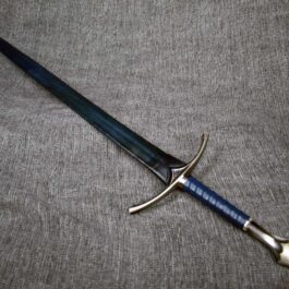 A Custom Leather Scabbard laying on top of a gray cloth.
