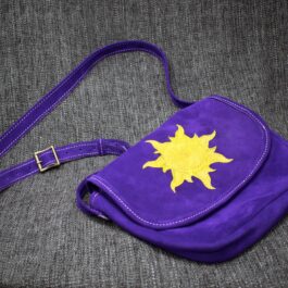 A Frontier Suede Saddlebag with a yellow sun on it.