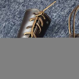 a pair of Simple Leather Bracers sitting on top of a blue carpet.
