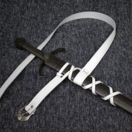 A black and white Integrated Sword Belt knife with a white strap around it.