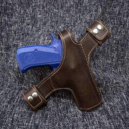 a blue and brown Handmade Leather Snap Loop Pancake Holster in a brown leather case.