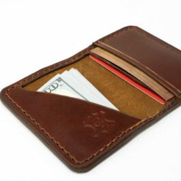 a wallet with a credit card and money sticking out of it.