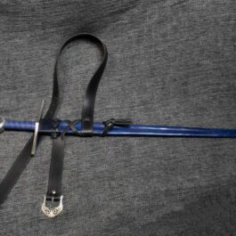 A Custom Leather Scabbard is laying on top of a piece of cloth.