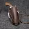 a brown leather sheath with a wooden handle.
