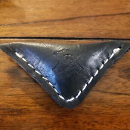 A Handmade Leather Finger Football on a wooden surface.