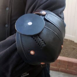 a man wearing a black leather elbow armor - renaissance clothing - renaissance clothing men - renaissance clothing women - renaissance clothing near me - renaissance costume ideas - sword baldrics - baldrics leather - baldric belt