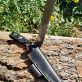 a knife that is on top of a piece of wood.