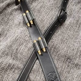 A black Handmade Leather Rifle Sling with vertical ammo loops laid on a cloth - Grommet's Leathercraft - renaissance clothing - renaissance art clothing - renaissance era clothing - leathercraft supplies - leathercraft accessories - leathercraft store near me - quality leather craft
