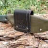 a knife with a leather sheath attached to it.