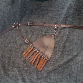 a piece of leather with fringes attached to it.