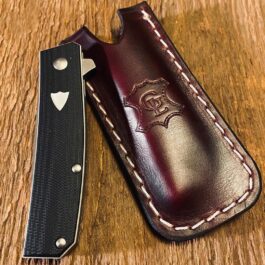 A Leather Pocket Slip for the Benchmade Tengu on a wooden table.