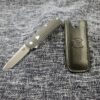a knife laying on top of a piece of cloth.