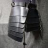 a black leather purse hanging on a wall.