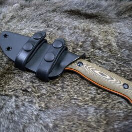a Benchmade Saddle Mountain Skinner Kydex Sheath laying on top of a furry surface.