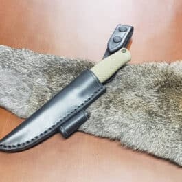 a knife laying on top of a fur covered table.