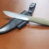 a knife laying on top of a knife holder.