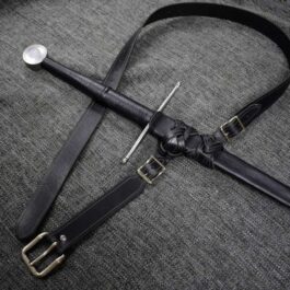A Custom Leather Scabbard laying on top of a gray cloth.