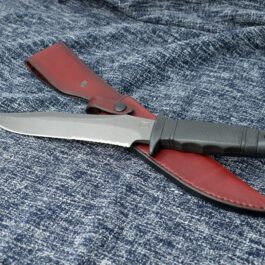 a Vertical Leather Sheath for the SOG Tigershark laying on a blue cloth.