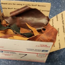 a box with a brown leather object inside of it.