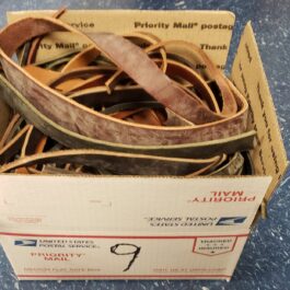 a box filled with lots of different types of belts.